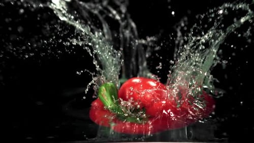 Super Slow Motion One Sweet Red Pepper Falls Into the Water with Splashes
