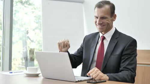 Professional Man on Video Call in Office