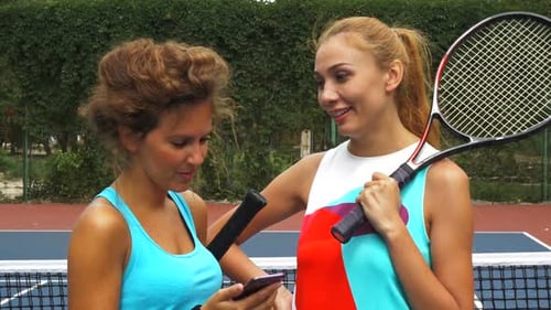 Women Friends Talking at Tennis Court with Phone