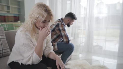 Upset Woman Sitting on Couch After Argument