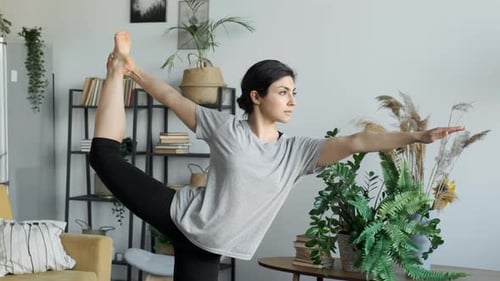 Woman Doing Yoga Pose in Living Room