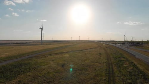 Windmills for Electric Power Production in the Meadow. Group of Windmills for Renewable Electric