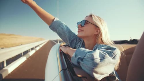 Woman Enjoying Convertible Ride on Rural Road