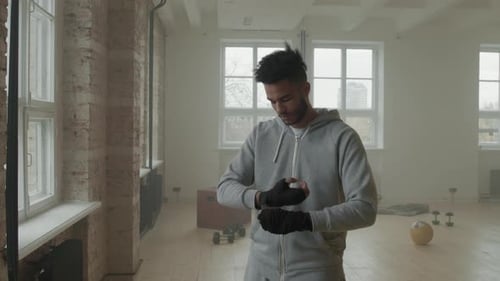 Young Man Wrapping Hands for Boxing Workout
