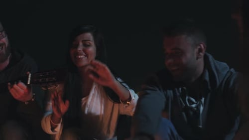 Friends Gathered at Night, Playing Guitar by Fire