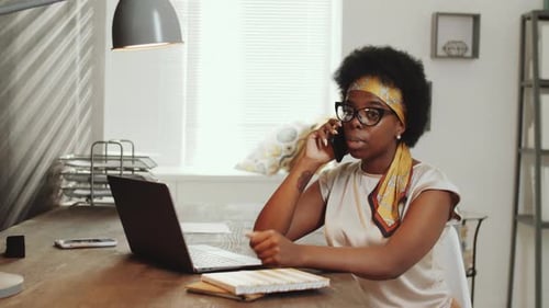 Afro-American Business Lady Having Phone Talk in Office