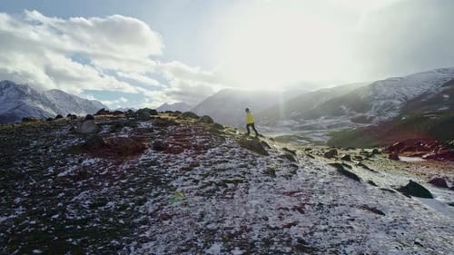 Man Standing On Rock Peak Snowy Winter Mountain Range Achievement Success Outstretched Arms Happines