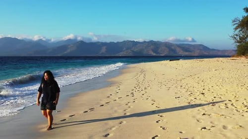 One girl enjoys life on relaxing island beach voyage by clear sea with white sandy background of the