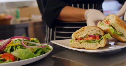 Chef Prepares Gourmet Sandwich Plate in Restaurant