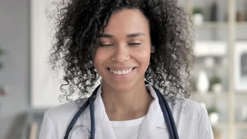 Smiling Medical Professional Wearing White Coat and Stethoscope