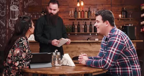 Couple Ordering at Cozy Cafe From Waiter