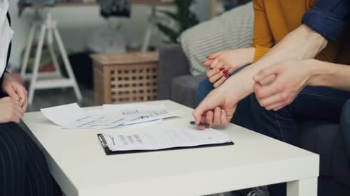 Close-up of Guy Signing Contract Buying House Then Taking Key and Shaking Hand