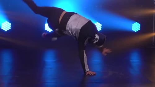 Young Talented Man Doing Brake Dancing Movements Close Up. Male Dancer in Streetwear Performs