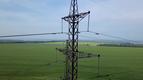 Electrical Tower Over Lush Green Rural Field