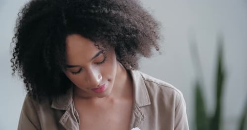 Woman Reads Documents on Couch at Home