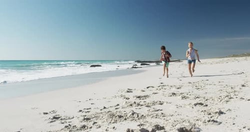 Boy and girl enjoying free time on the beach together