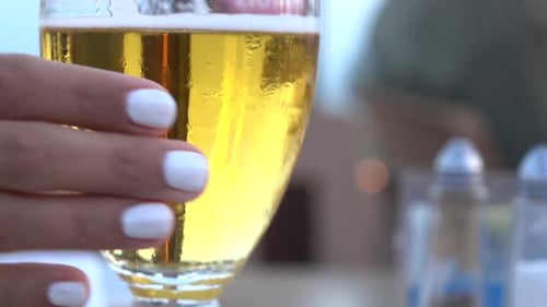 Close Up of Beer in a Glass Being Held