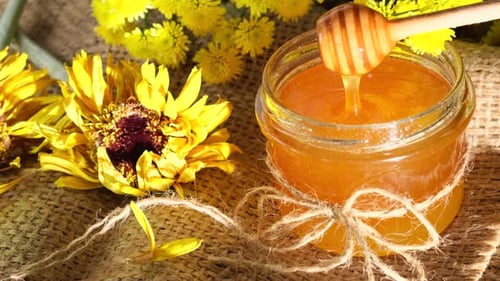 Close Up of Honey Jar with Sunflower