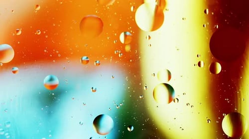 Real close up oil bubbles in water rotation with color gradient abstract mixing background.