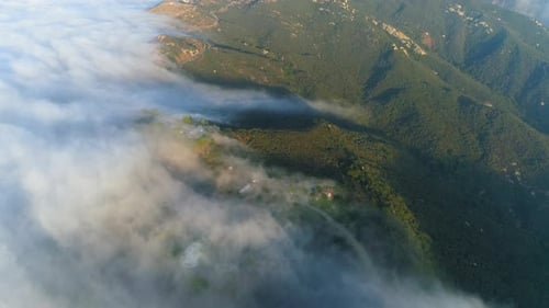 Majestic Mountain Range Enshrouded in Thick Clouds