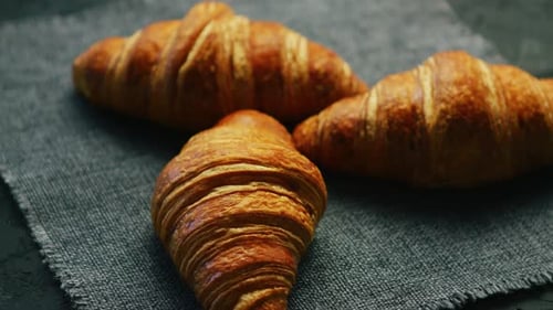 Golden Croissants on Textured Background