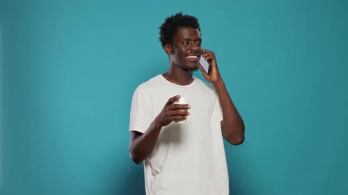 Black Person Using Smartphone for Phone Call in Studio