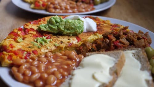 Close Up of Vegan Full English Breakfast of Tofu Scramble Beans Soya Meet and Wholegrain Bread