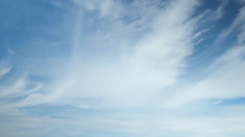 Clouds Moving Slowly Through Blue Sky
