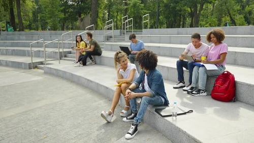 Students Relaxing Together on Outdoor Steps