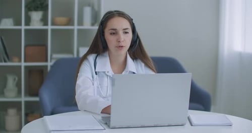Young Doctor Telehealth Consultation with Laptop and Headset