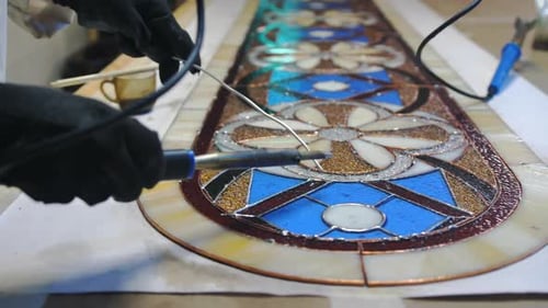 Craftsperson Creates Stained Glass Art in Studio