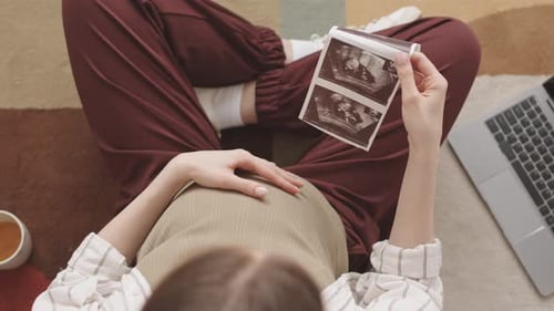 Pregnant Woman Holding Baby Ultrasound Scan