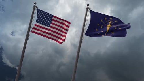 USA and Indiana Flags Waving Against Cloudy Sky