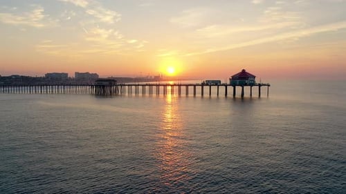 4k Ariel Drone shot of the Huntington Beach Pier in sunny Surf City California
