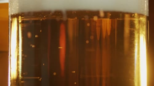 Close-Up of Golden Beer with Bubbles and Foam