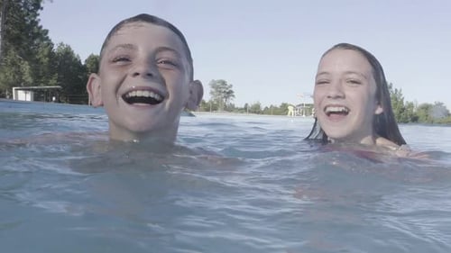 Joyful Children Playing in Swimming Pool on Summer Day