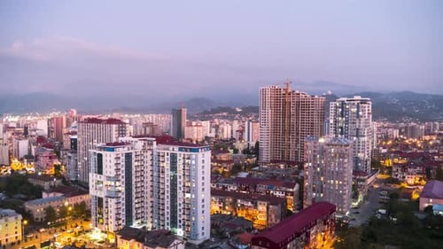 Day To Night Timelapse of City Space with Skyscrapers and Windows Changings Light. Batumi