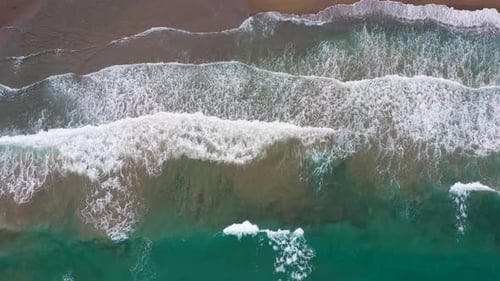 Aerial View of the Mediterranean Coast Waves Reach the Deserted Sandy Beach