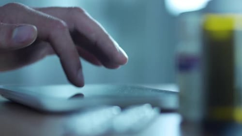 Hand Swiping Tablet Touchscreen in Close Up Shot