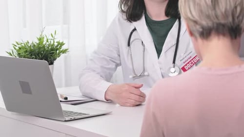 Doctor Consults with Patient and Shakes Hands