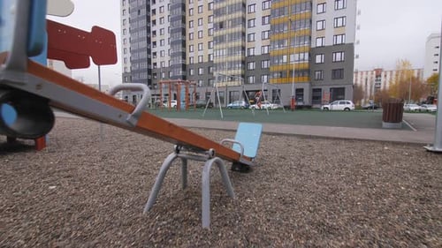 Empty Playground with Attractions Near Apartment Building