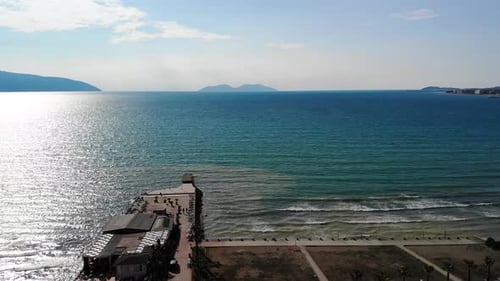 Drone Shot of the Beach in a Bright Day with Palm Trees and Blue Water