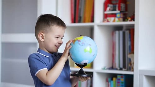 Boy Exploring Globe Education in Home Setting
