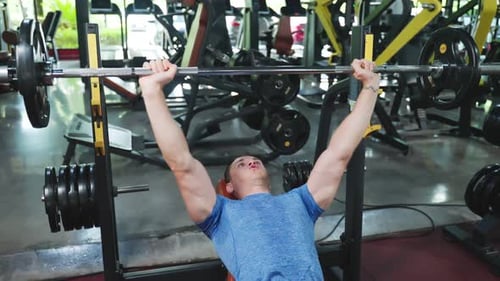 Active Caucasian Fitness trainer sportman or athlete lift up weight lifting or barbell in stadium.