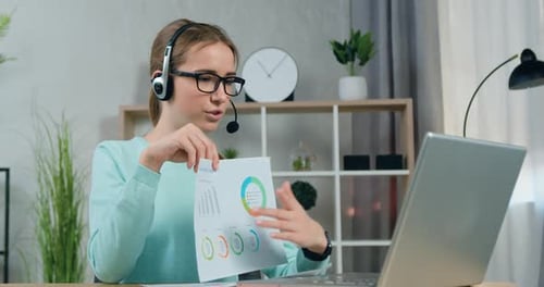 Female Student in Headset Has Video Chat with College Teacher