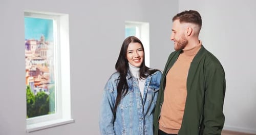 Close Up Portrait of Cheerful Young Caucasian Married Couple Wife and Husband Standing in New