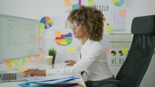 Young Adult Working At Desk At Computer