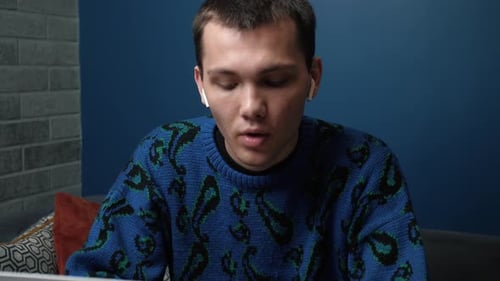 Young Adult Talking to a Computer Indoors