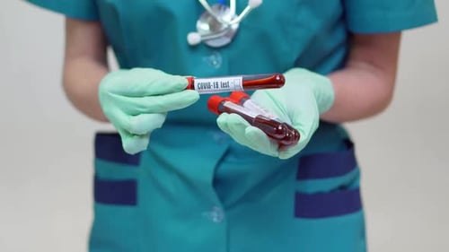 Medical Professional Holds Blood Samples for COVID-19 Test