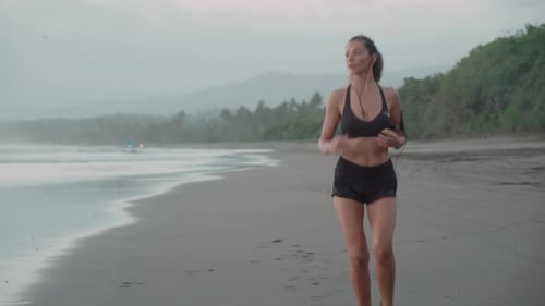 Woman Stopping after Jogging on Beach